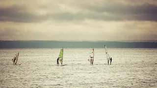Five windsurfers on the open sea
